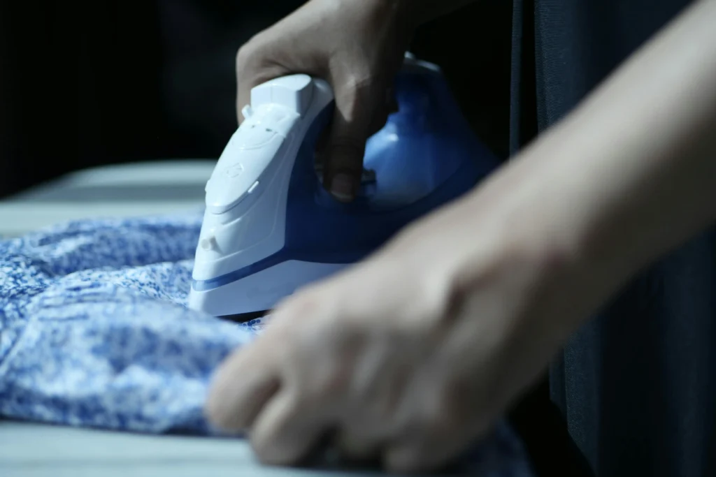 Clothes iron pressing fabric